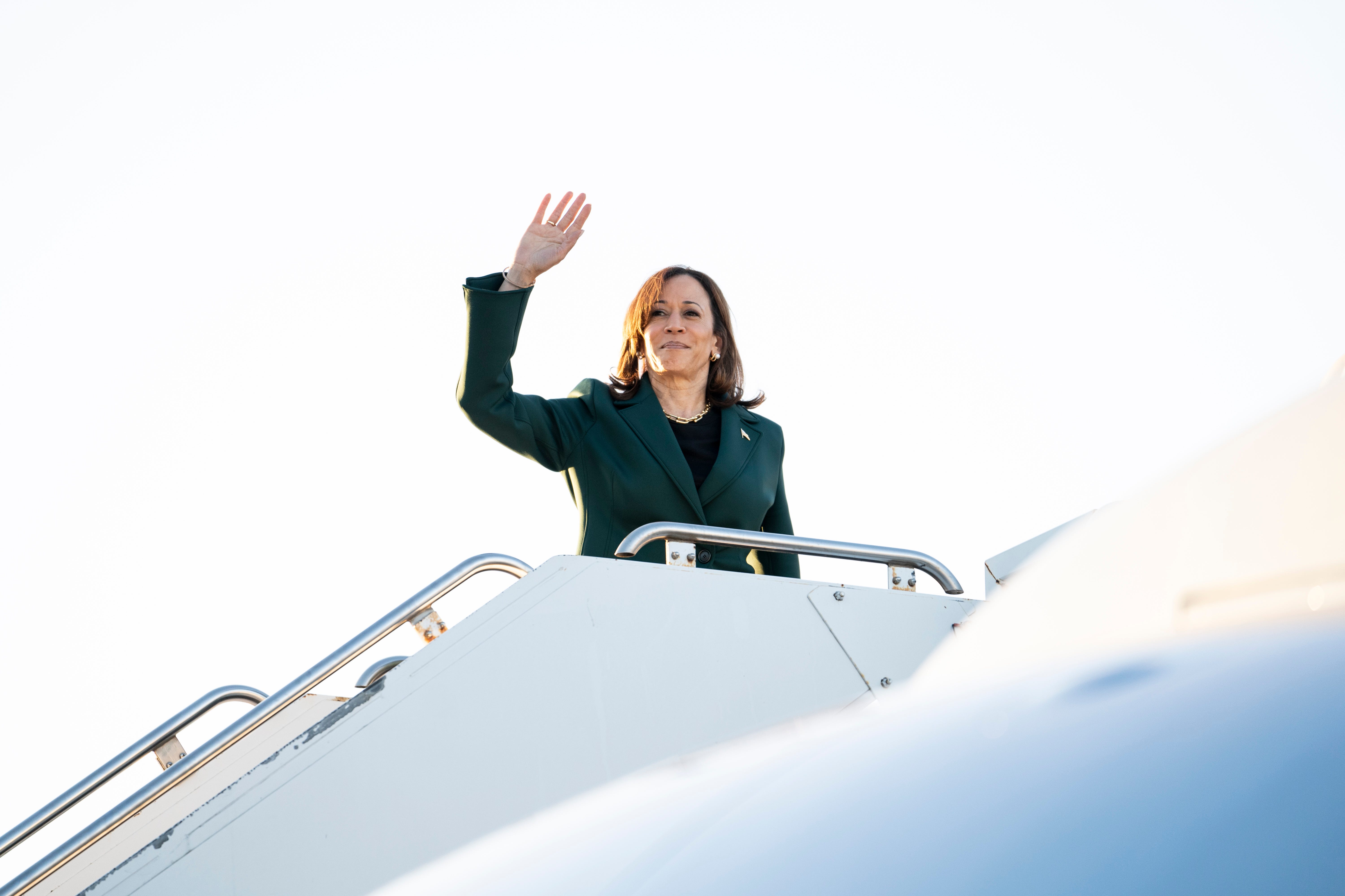 Vice President Kamala Harris waves as she boards Air Force Two in Oakland County, Michigan.