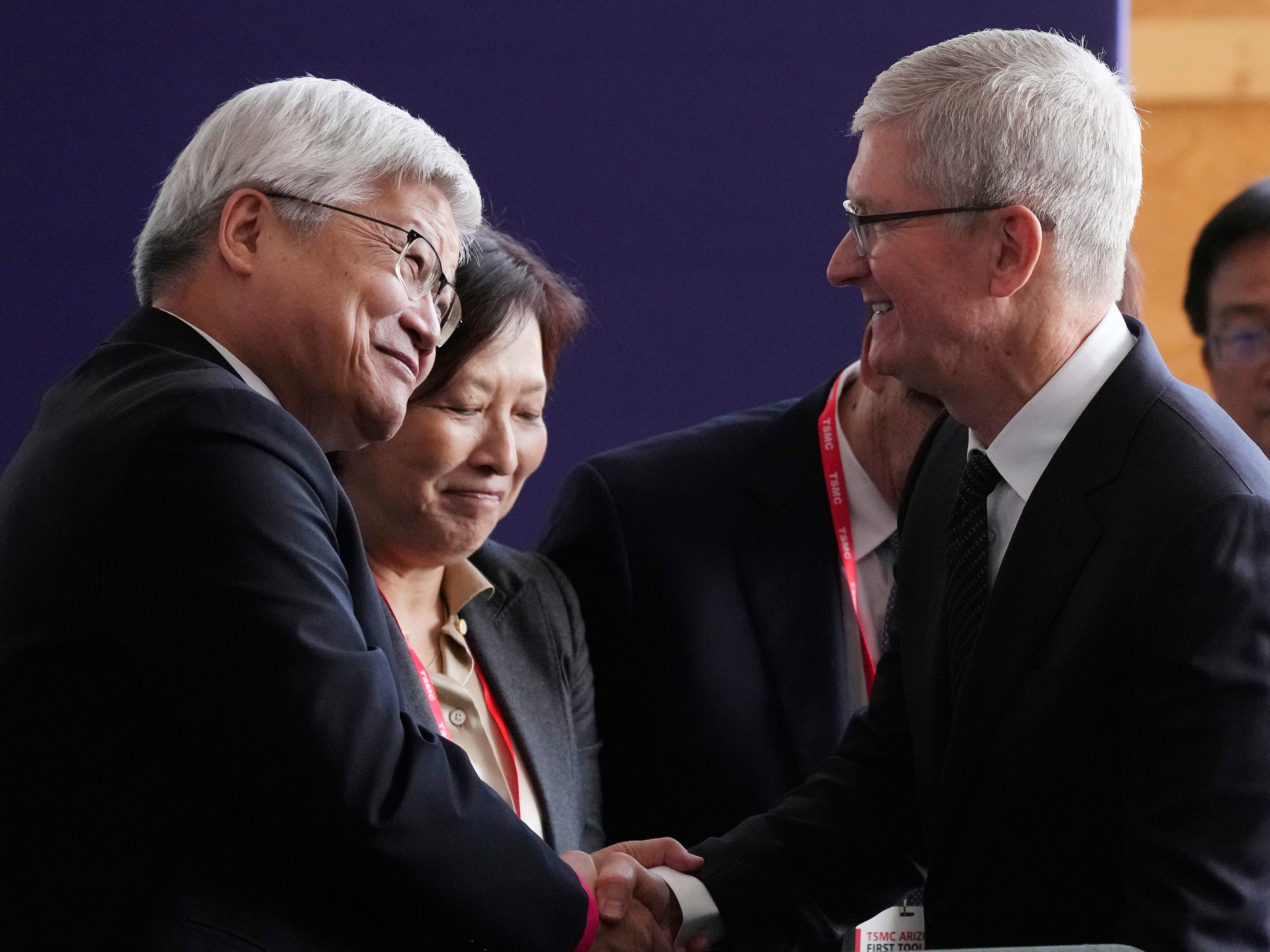 Taiwan Semiconductor Manufacturing Company CEO C.C. Wei, left, shakes hands with Apple CEO Tim Cook