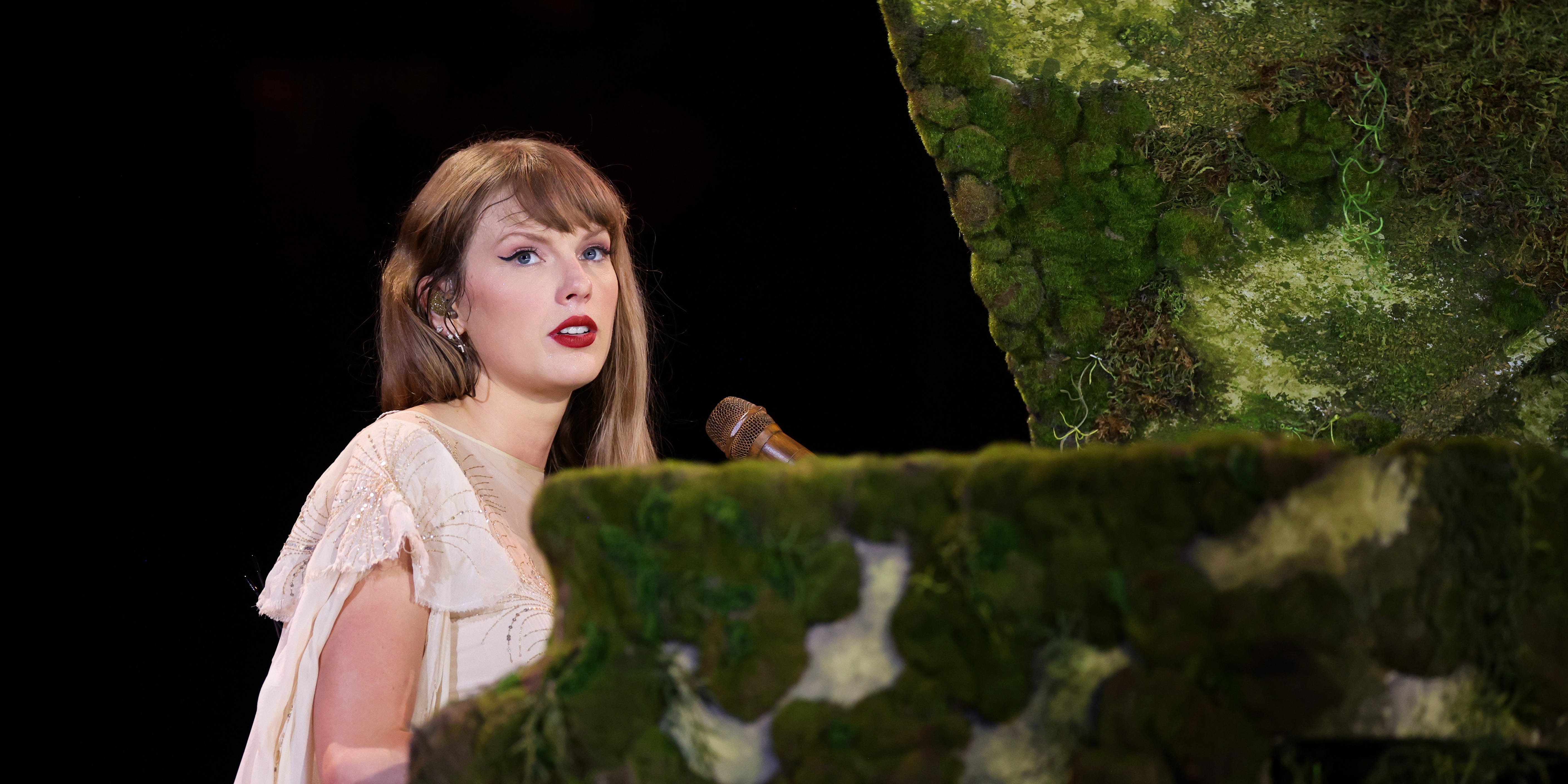 Taylor Swift playing the piano during a performance on The Eras Tour.