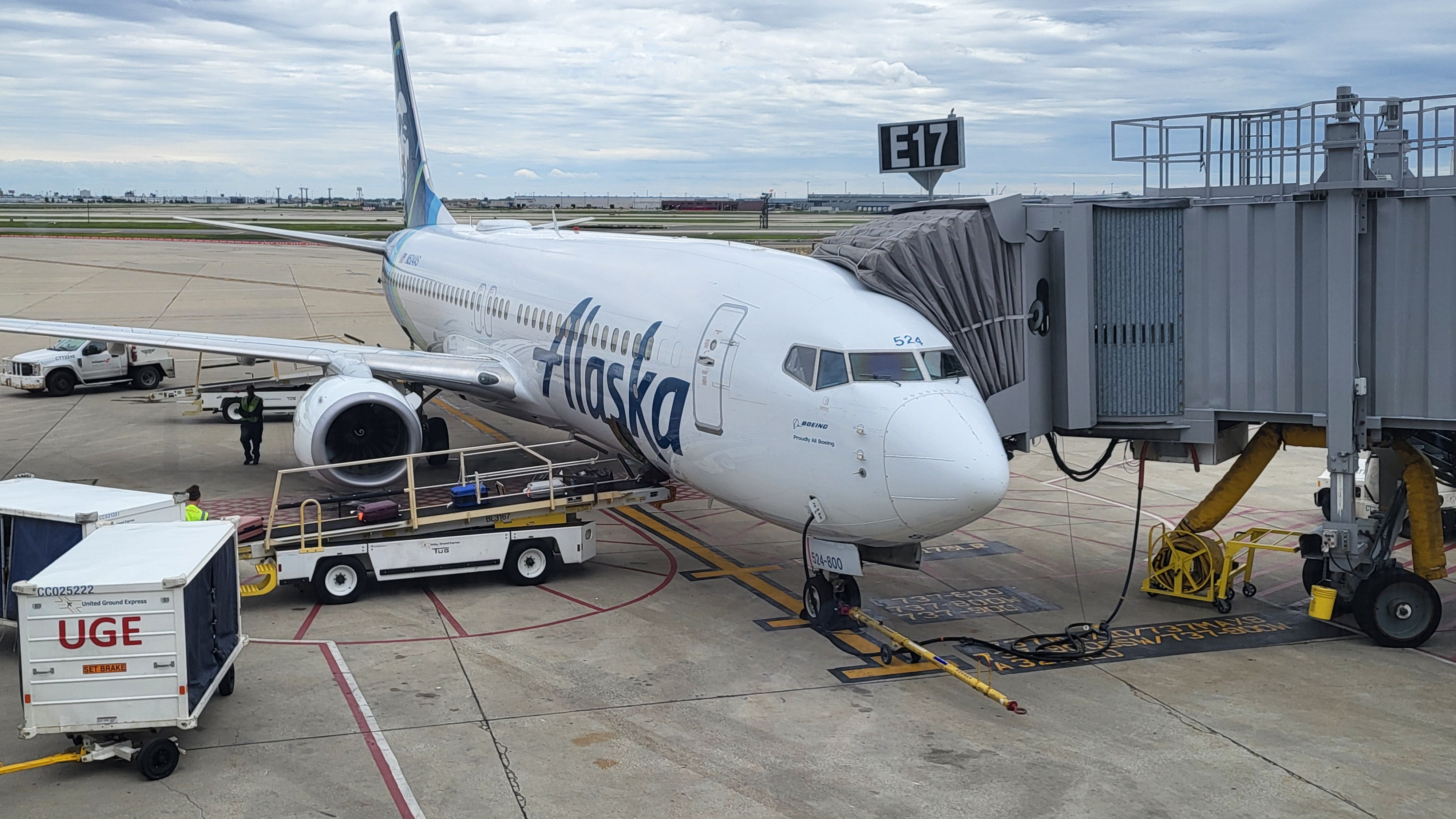 Alaska Airlines plane on tarmac with luggage being loaded into it