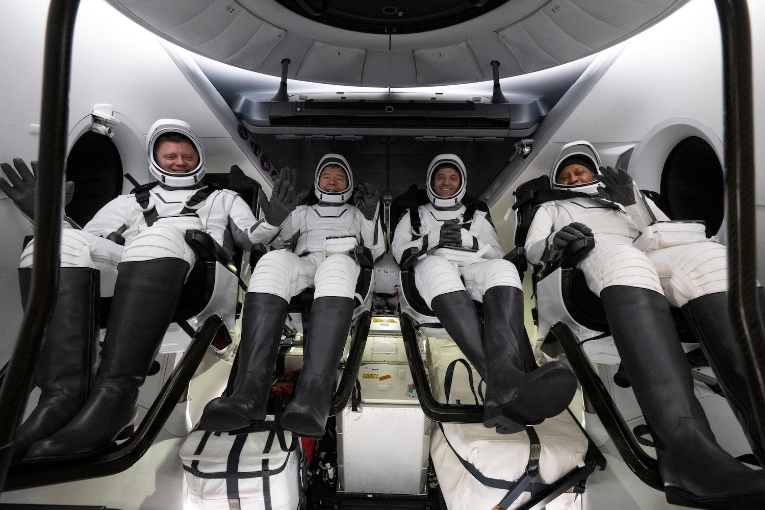 Roscosmos cosmonaut Alexander Grebenkin, left, NASA astronauts Michael Barratt, second from left, Matthew Dominick, second from right, and Jeanette Epps, right are seen inside the SpaceX Dragon Endeavour spacecraft onboard the SpaceX recovery ship MEGAN shortly after having landed in the Gulf of<br /><a href=