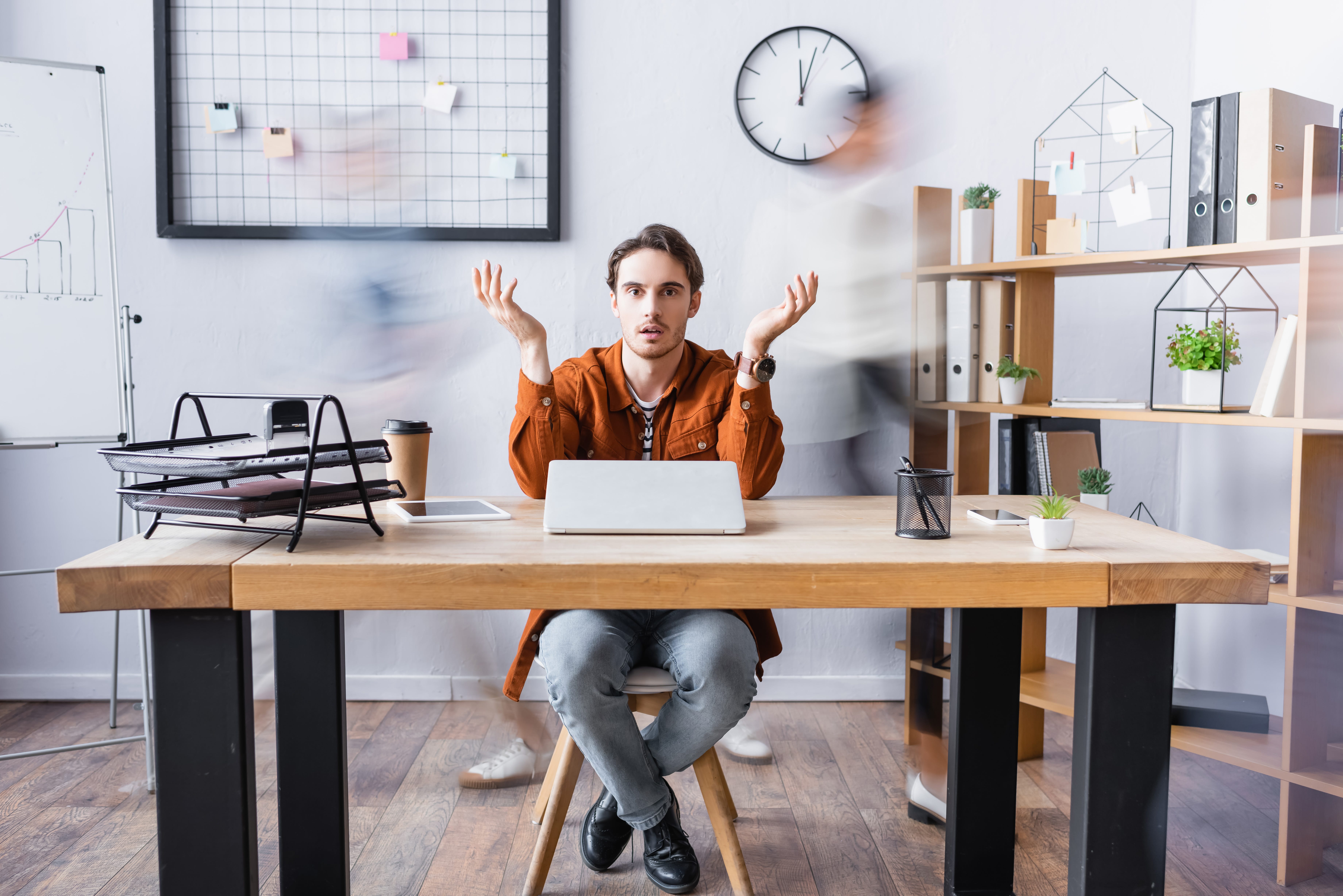 A Zillennial man confused at his desk