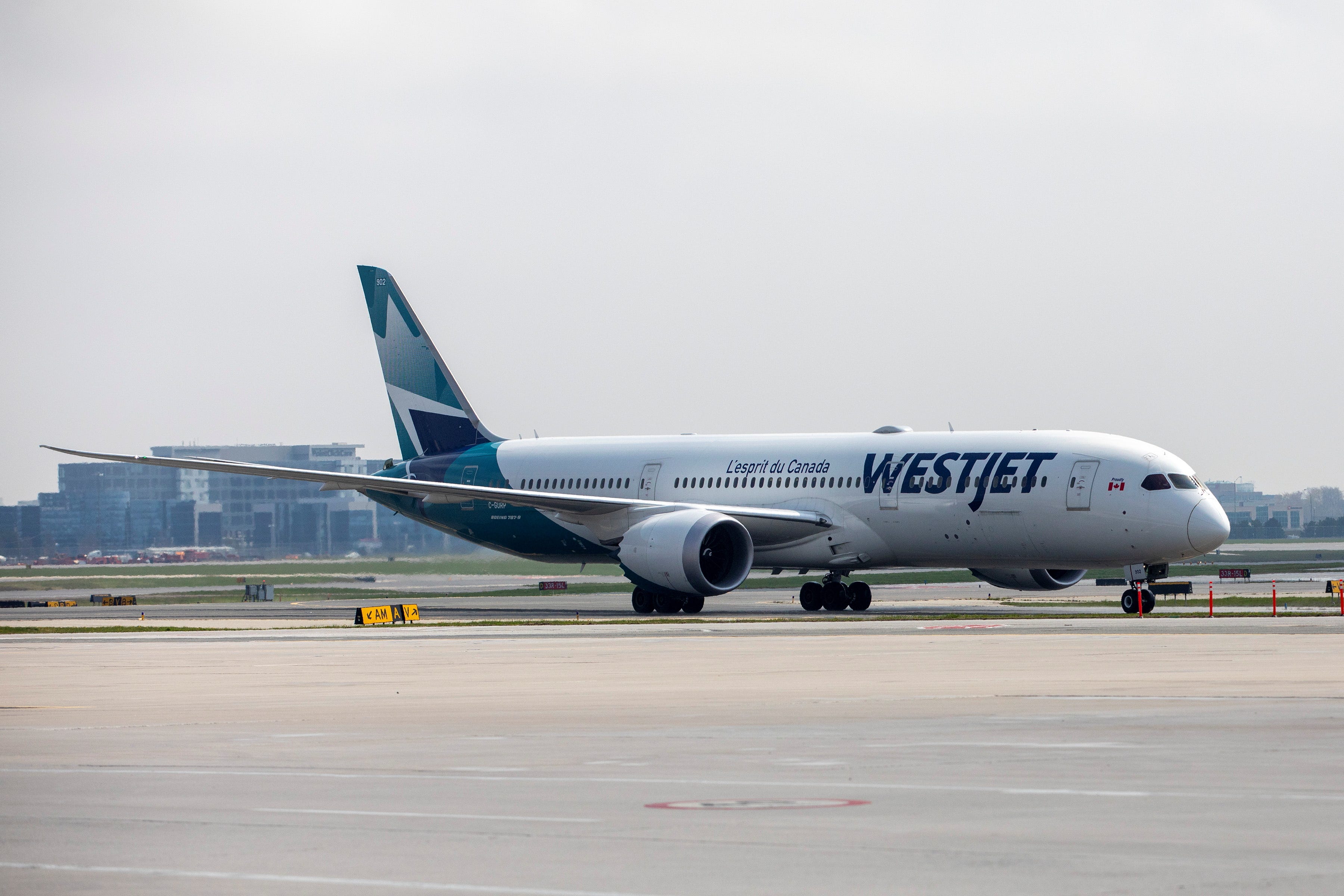 A WestJet Boeing 787-9 Dreamliner airplane taxis along a runway at Toronto Pearson Airport in Mississauga, Ontario, Canada.